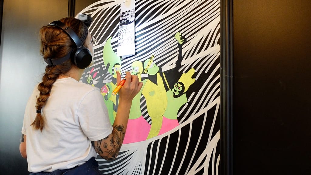 Painting a mural at cafΓ© des Grand-Places in Fribourg, Switzerland.