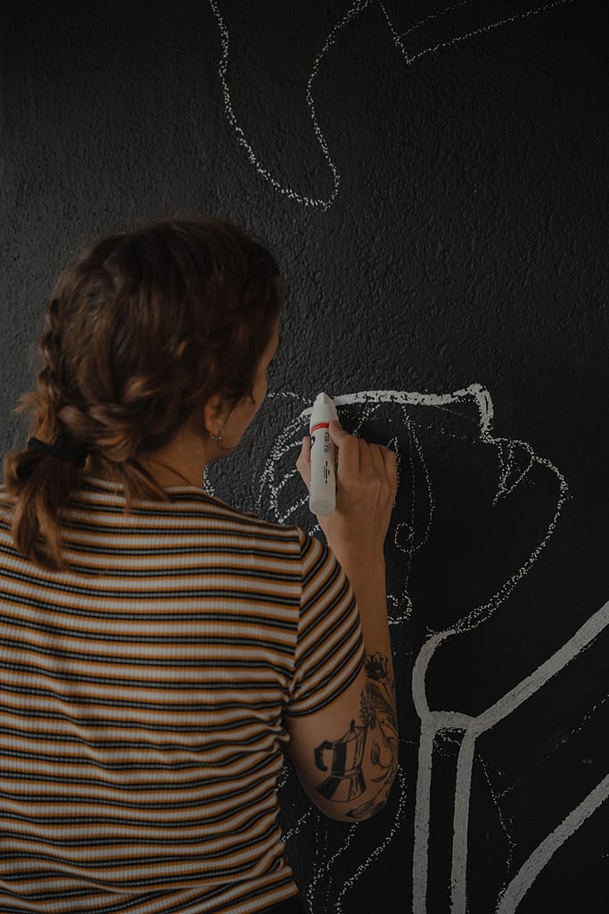 Painting on the wall for one of the mural exhibitions.